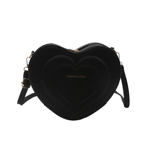 Minimalist black heart-shaped crossbody bag with gold hardware and layered design