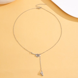Detailed tennis racket necklace with zircon accents and a shuttlecock pendant in silver