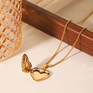 Collier médaillon cœur en or 18K avec nacre blanche sur une surface blanche