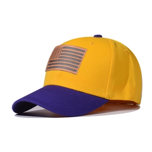 Detailed view of American flag patch on a yellow and purple contrast baseball cap
