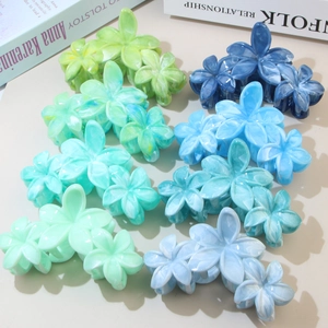 Detailed display of colorful flower-shaped hair claws with elegant marble resin texture