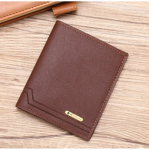 Close-up of brown leather wallet featuring a gold metal brand logo on wood texture