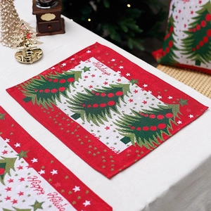 Festive Christmas table mat with red and white jacquard pattern and Happy Holiday text