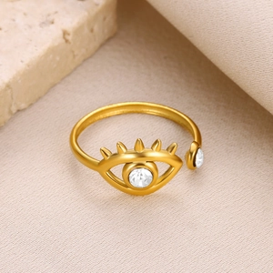 Macro view of adjustable gold evil eye ring with sparkling white zircon setting