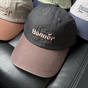 Detail of color-block baseball caps with premium letter embroidery in four color options