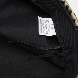 Interior detail of leopard print beret with size 58 label and cotton polyester fabric