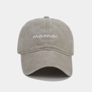 Close-up of white mama cursive embroidery on a vintage washed cotton baseball cap