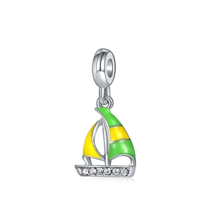 Detail of sailboat charm with green yellow enamel and white zircon stones on white background