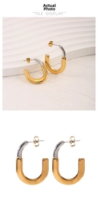Detail of two-tone 18K gold and silver plated U-shaped stainless steel earrings