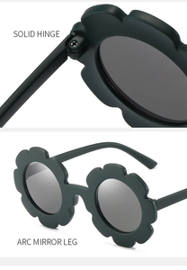 Detail of solid hinge and arc mirror leg on flower-shaped green kids sunglasses