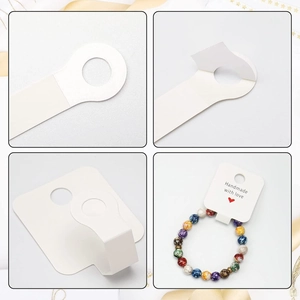 Detailed views of white paper jewelry display cards with Handmade with love text