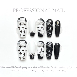 Close-up of handmade press-on nails with 3D resin flowers, pearls and black crosses