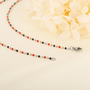 Collana bohémien in acciaio al titanio con pietre colorate e chiusura a moschettone