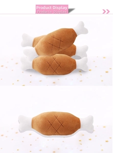 Detail of plush squeaky dog toy with chicken drumstick design and soft stitched texture