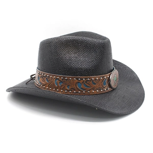 Close-up of woven black straw cowboy hat with ethnic patterned band and turquoise buckle