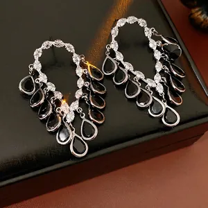 Sparkling silver needle earrings with black teardrop gems and zircon tassel design
