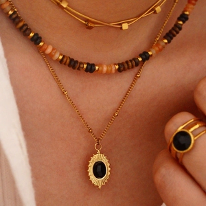 Layered 14K gold plated necklace with black agate sunburst pendant and beaded boho jewelry