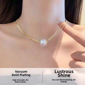 Close-up of double-layer gold titanium steel necklace with elegant white pearl pendant