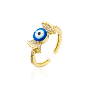 Macro view of gold-plated evil eye ring with blue enamel and sparkling zircon accents