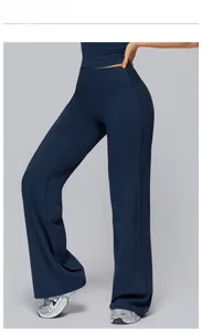 Detail view of high waisted navy blue flare yoga pants in shiny elastic fabric