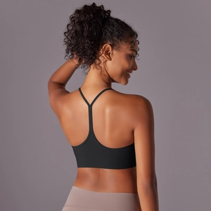 Detail of racerback design on black sports bra with brushed fabric texture