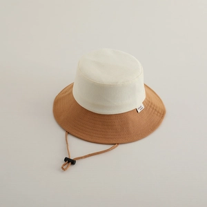 Detail view of two-tone bucket hat with fine stitching and adjustable drawstring