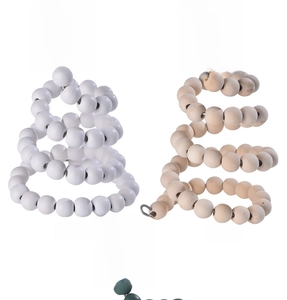 Detail of wooden bead spiral Christmas trees with rustic star toppers in white and natural