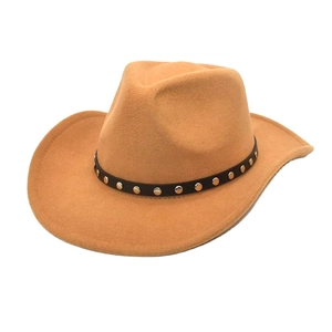 Close-up of a camel felt cowboy hat featuring a black leather band with metallic rivets