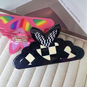 Elegant acetate hair claws featuring heart patterns in cloud and butterfly shapes