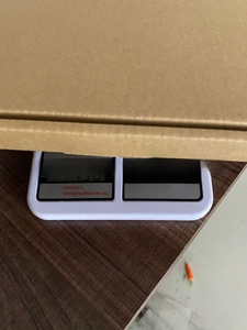 Kitchen scale weighing a Mandala Yoga night light in a corrugated cardboard shipping box