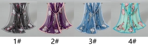Detailed view of four sheer floral chiffon scarves hanging in dark and pastel colors