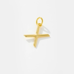 Detail of a polished gold letter X pendant featuring a minimalist metallic design