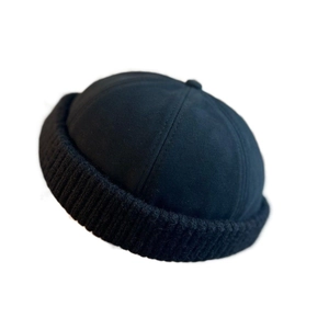 Minimalist black brimless sailor docker cap with cotton twill and knit ribbed texture