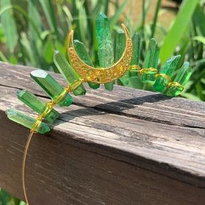 Detail of green crystal headband with gold wire wrap and crescent moon accessory