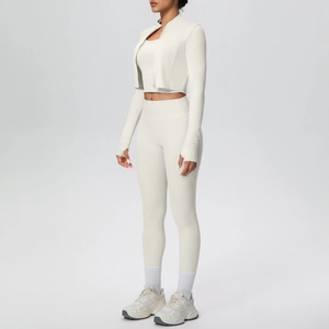 Detailed side view of three-piece fitness set featuring thumbhole cuffs and high waist pants