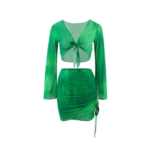 Detail of green tie-dye mesh crop top with V-neck tie and matching ruched mini skirt