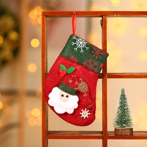 Detailed close-up of a red felt Christmas stocking with Santa Claus applique and snowflakes