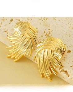 Macro shot of gold-plated titanium steel irregular vortex earrings with textured design