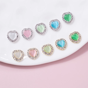 Cat eye heart nail charms with rhinestone border in gold and silver base colors