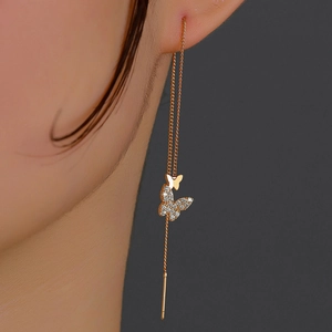 Detail of rose gold butterfly earrings with sparkling cubic zirconia on long chain