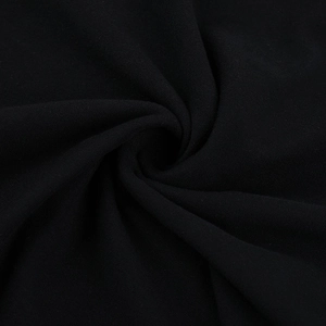 Detail shot of black knitted fabric texture with elegant central pleated fold pattern