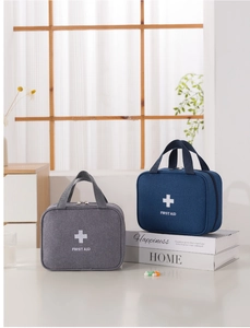 Detail of portable first aid bags in grey and navy blue with durable fabric handles