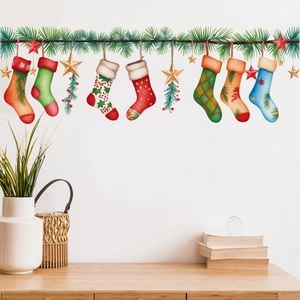 Christmas wall stickers with stockings and pine branches on a white living room wall