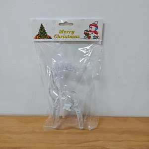 Detail of a transparent acrylic reindeer LED light with a battery box in packaging
