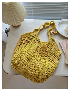 Detailed view of a yellow woven cotton mesh tote bag in a cozy home setting with soft lighting