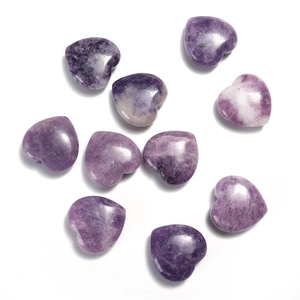 Flat lay of ten polished heart-shaped purple crystals with natural stone textures