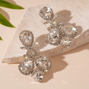 Macro detail of luxury water drop earrings featuring sparkling crystals on stone base