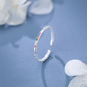 Adjustable S925 silver ring featuring vibrant colorful zircons on a fresh floral background