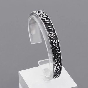 Detail of Viking Thor hammer bracelet with Celtic knots and Nordic rune engravings
