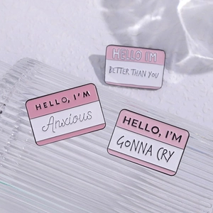 Geometric enamel name tag pins featuring humorous English phrases in pink and white